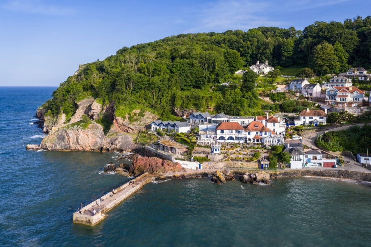 Aerial view of Cary Arms and Spa nestled in Babbacombe Bay, a luxury dog-friendly hotel on the Devon coast.