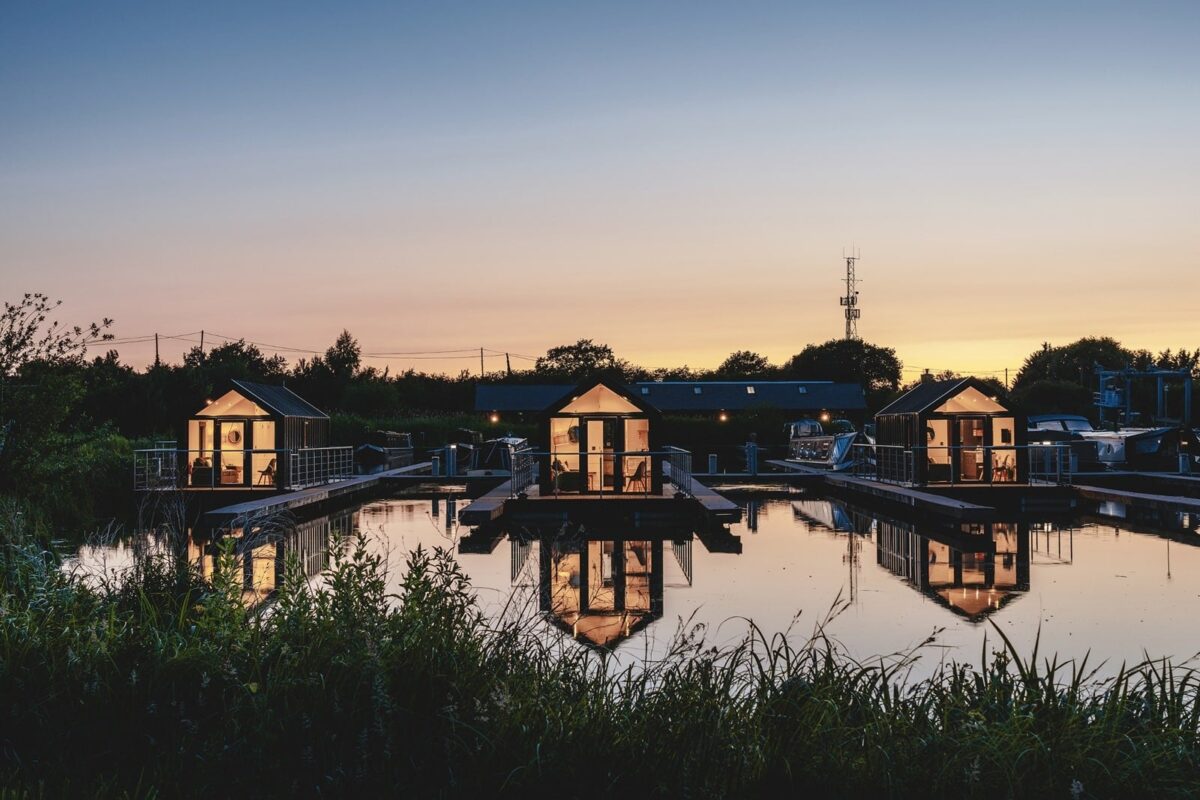 The unique dog-friendly floating pods at Tattenhall Marina, Cheshire with a beautiful sunset reflecting on the water