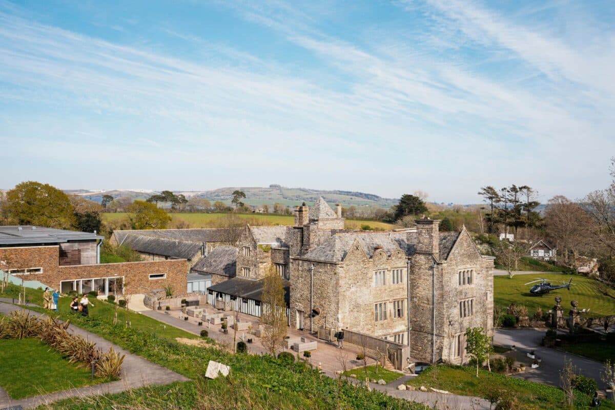 A view of the Boringdon Hall Hotel & Spa from the grounds, with a helicopter on the lawn