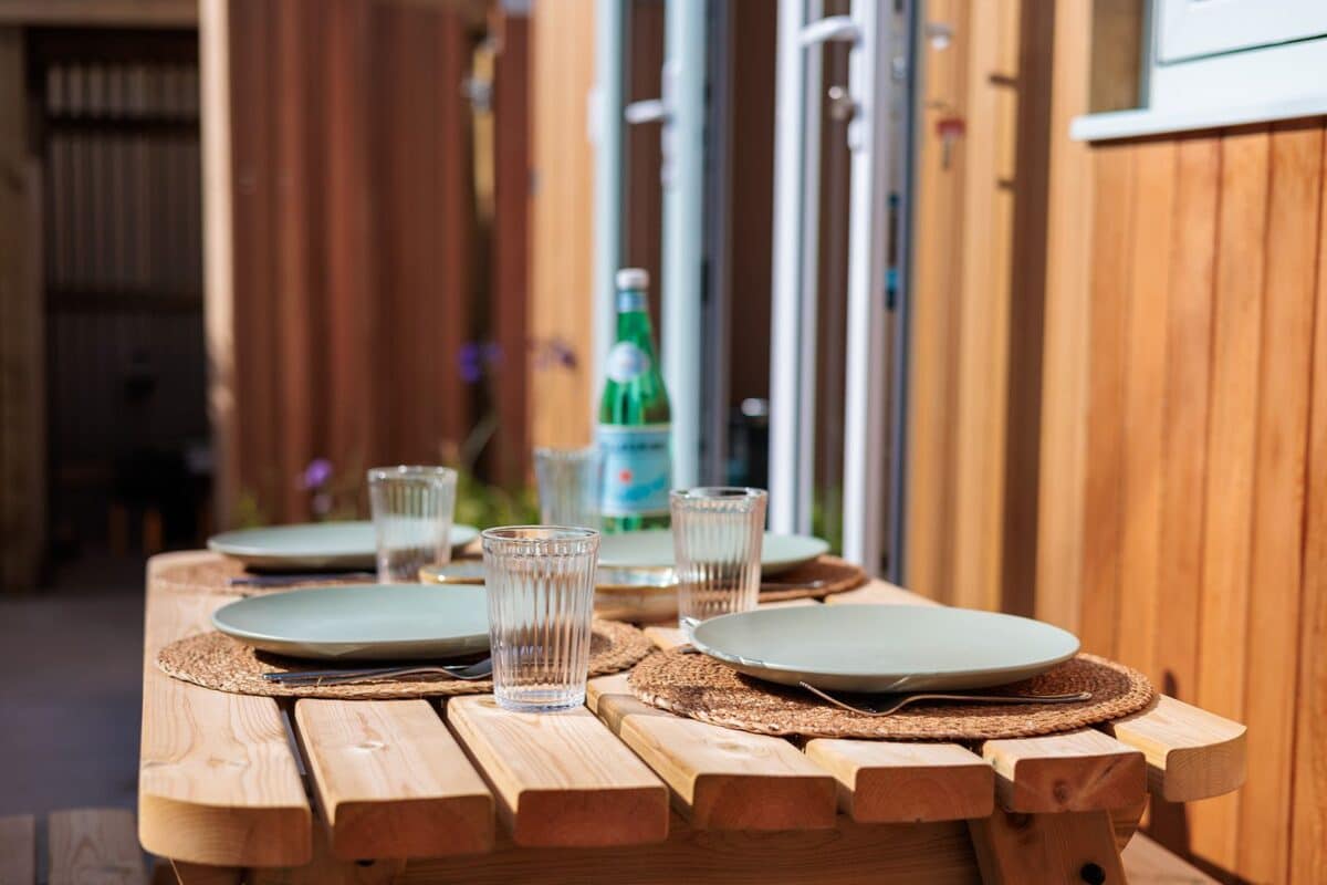 An outdoor dining table at The Watershed by Croyde Beach in Devon