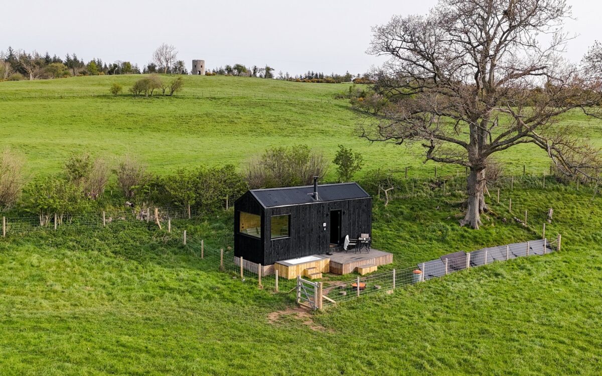 Aerial view of Castor dog-friendly off-grid cabin nestled in green countryside near Abergele, North Wales