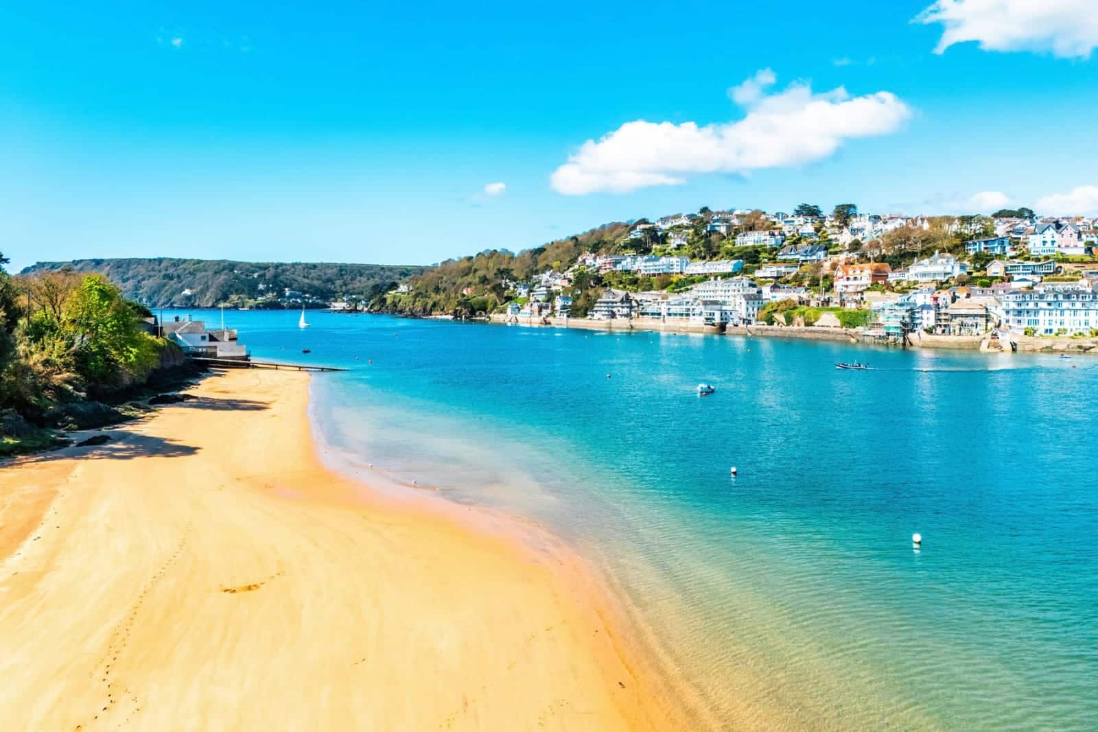 Aerial view of the sandy beach and turquoise water of the estuary at Salcombe, Devon