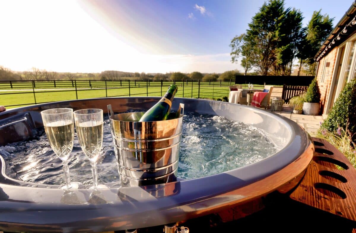 Wood-fired hot tub with champagne and countryside views at The Shooting Lodge at Mount Pleasant Barns, Walton, Warwickshire