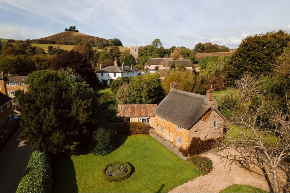 Aerial view of The Old Post Office and Symondsbury village with Colmers Hill behind, Symondsbury Estate, Bridport, Dorset