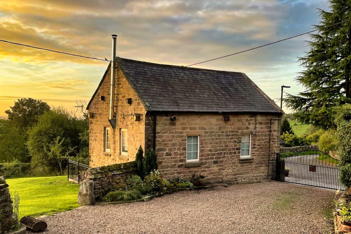 Stone exterior of The Old Chapel at sunset, a dog-friendly converted chapel near Matlock in the Peak District
